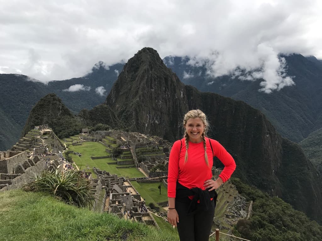 Kendra at Machu Picchu with the ruins and mountains behind her